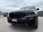 A BMW X5 in a satin black wrap
