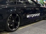 Vinyl signage laid along the door of a black Audi RS7