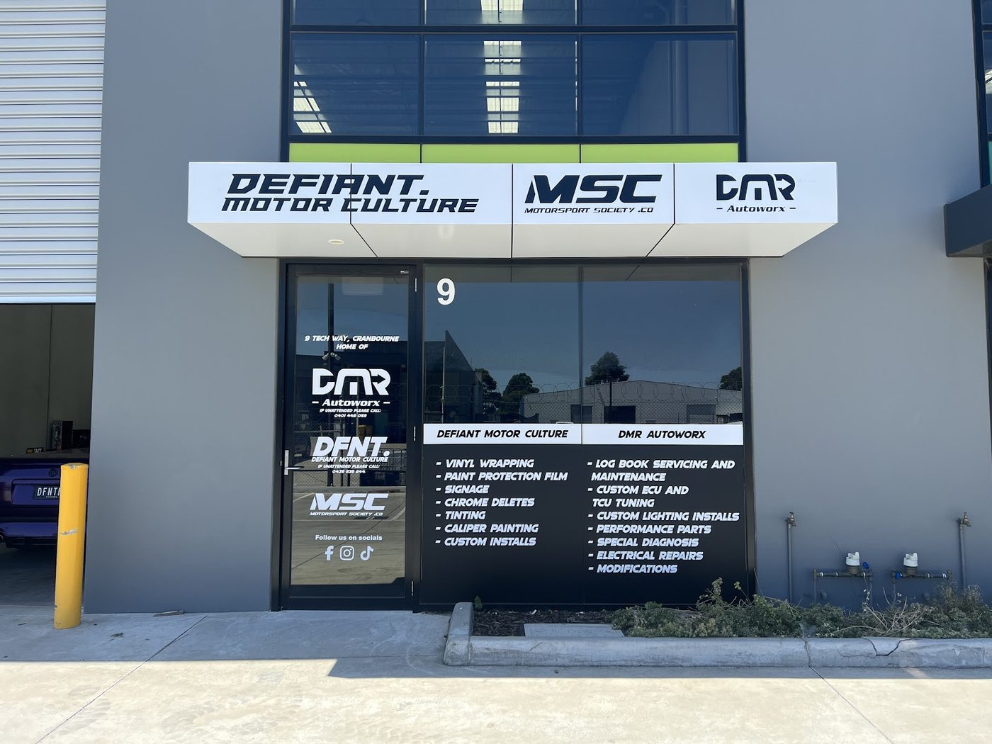 The Defiant Motor Culture shopfront at 9 Tech Way, Cranbourne, with the service board in the window